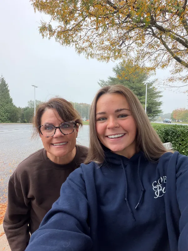 A selfie of two of the Code Brew crew under a tree in fall colors