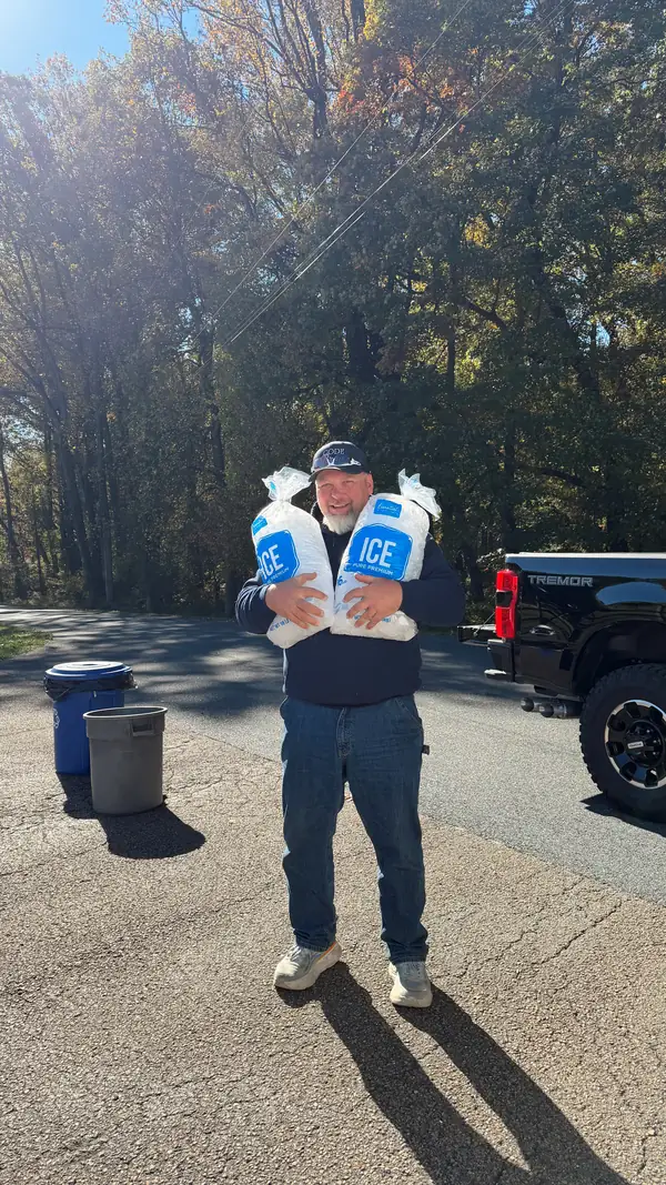 Rick hugging two big bags of ice